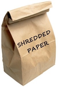 closed brown paper bag with shredded paper inside it