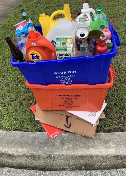 recycle bins stacked and set out curbside for collection