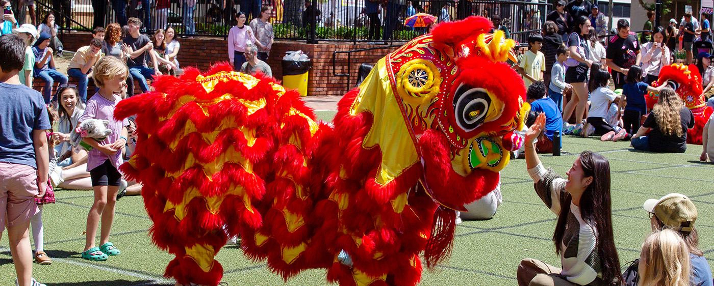 Lion dancer interacts with crowd at Gainesville Asian Festival