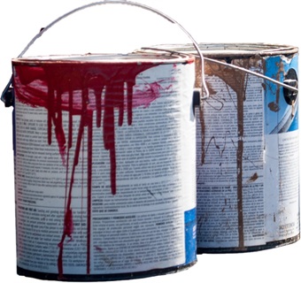 Two cans of old paint with some paint spilled on the paint can label