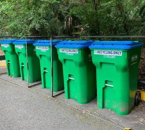 green apartment recycle carts in a row