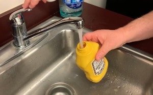 rinsing out a mustard bottle