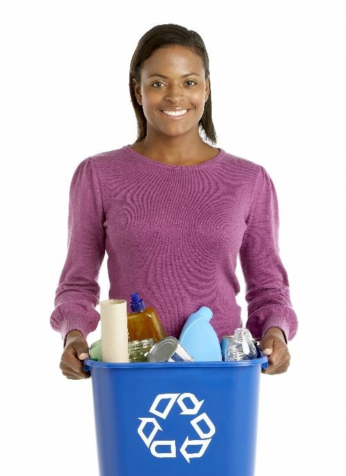 young woman holding a blue recycle bin full of recyclables
