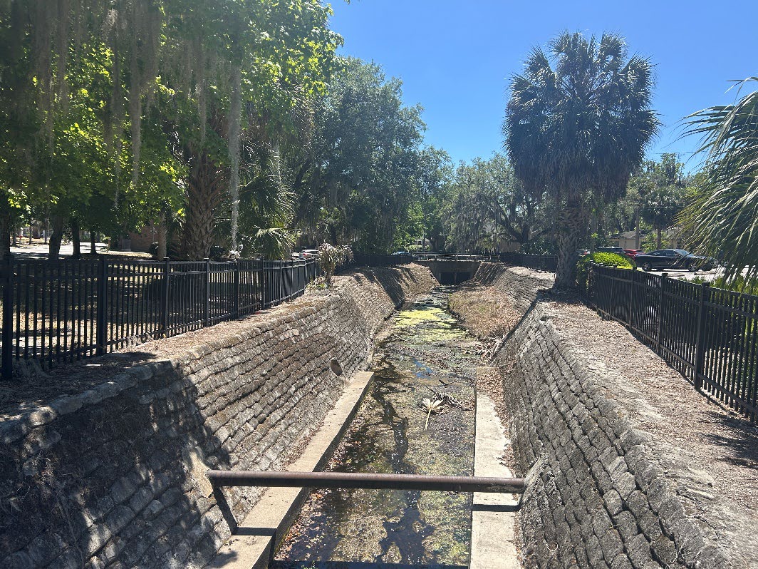 Image of pipe above the Sweetwater Branch Creek on the project site. 