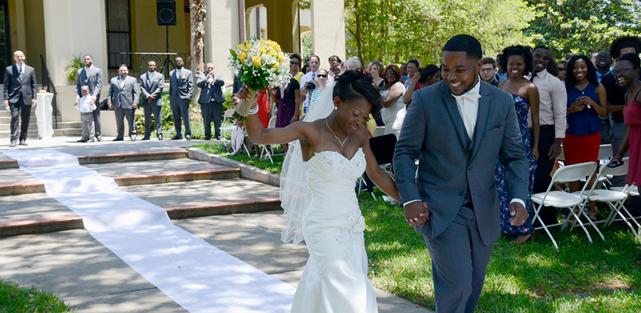 Smiling couple walk from the altar